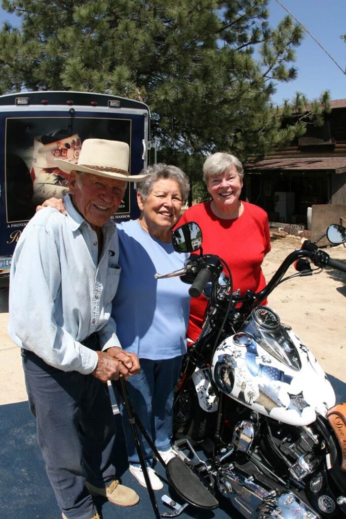John Finn, Frances Carmichael and Lil Larkin posing beside Metal of Honor