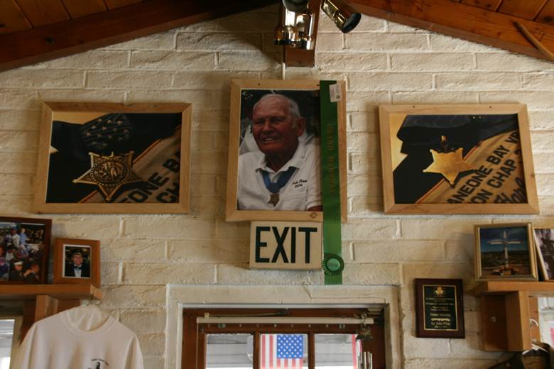 Harbaugh’s photos of John Finn and his Medal of Honor displayed on the tribute wall inside the La Posta Diner