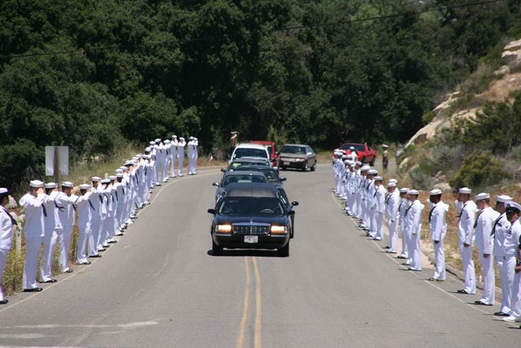 John Finn’s hearse slowing to a crawl as it passes ranks of Sailors