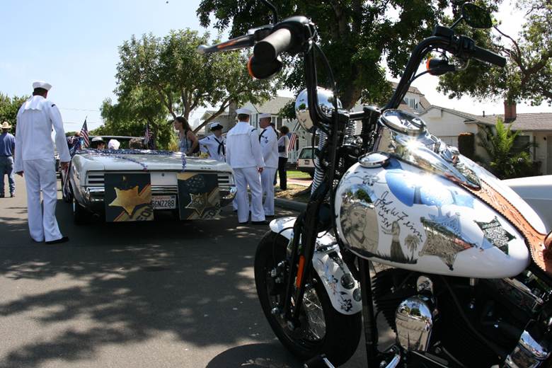 Metal of Honor staged for the Coronado parade beside John Finn’s escort convertible decorated with photos of his Medal of Honor