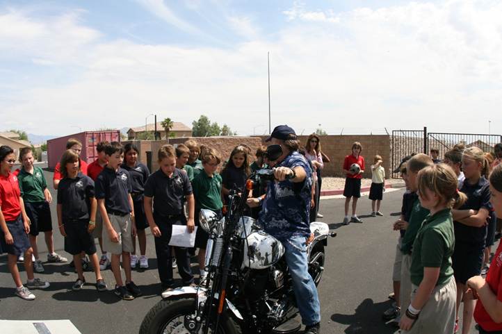 A 4th grade class in Las Vegas gathered around the Pearl Harbor tribute motorcycle