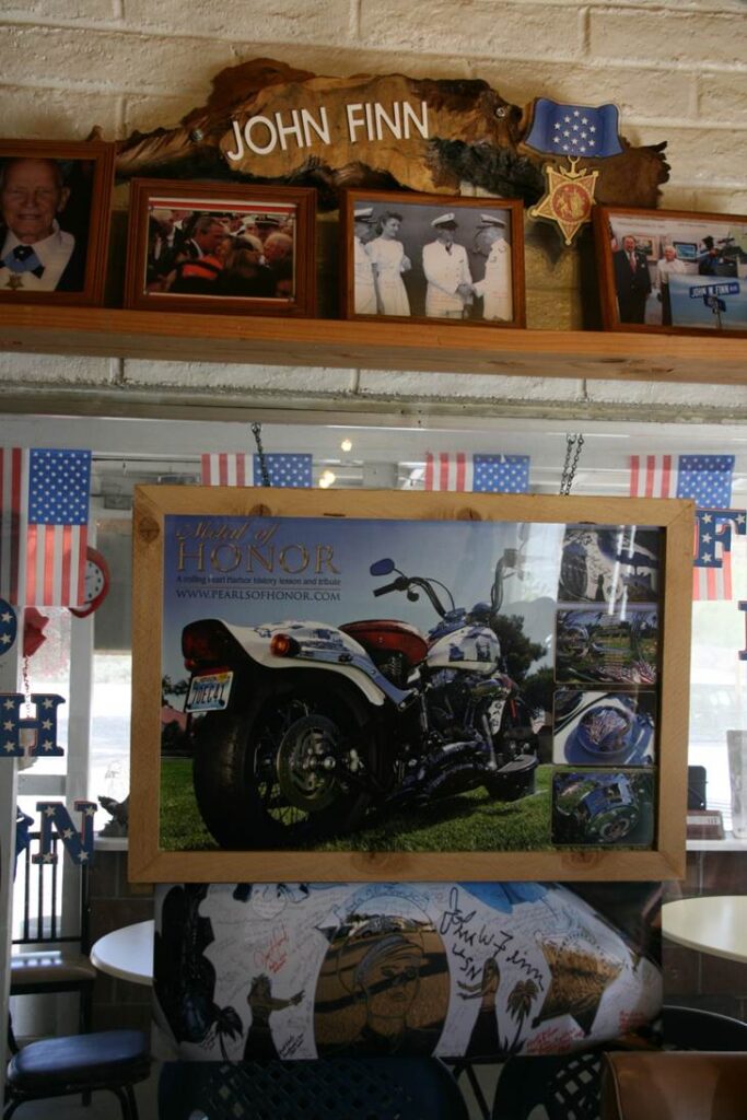 The John W. Finn tribute wall inside the La Posta Diner, including a large poster of Metal of Honor