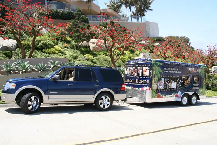 The navy blue 2008 Ford Expedition towing the vinyl-wrapped 16-foot Interstate trailer that carried Metal of Honor