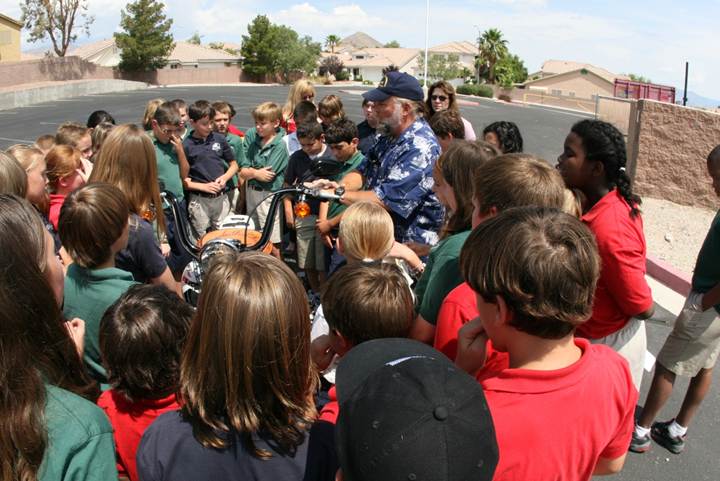 Schoolchildren learning Pearl Harbor history from the engraved chrome of Metal of Honor
