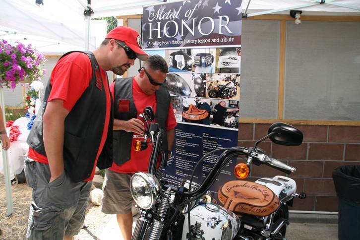John Finn’s friends and fans looking over Metal of Honor at the birthday party