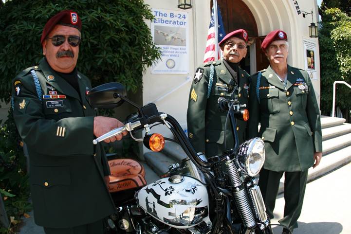 Members of San Diego’s All Hispanic Army Airborne unit viewing the tribute motorcycle